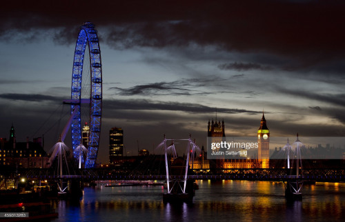 LONDON, UNITED KINGDOM - DECEMBER 25:  The sun sets across Westminster and the London Eye on Christm